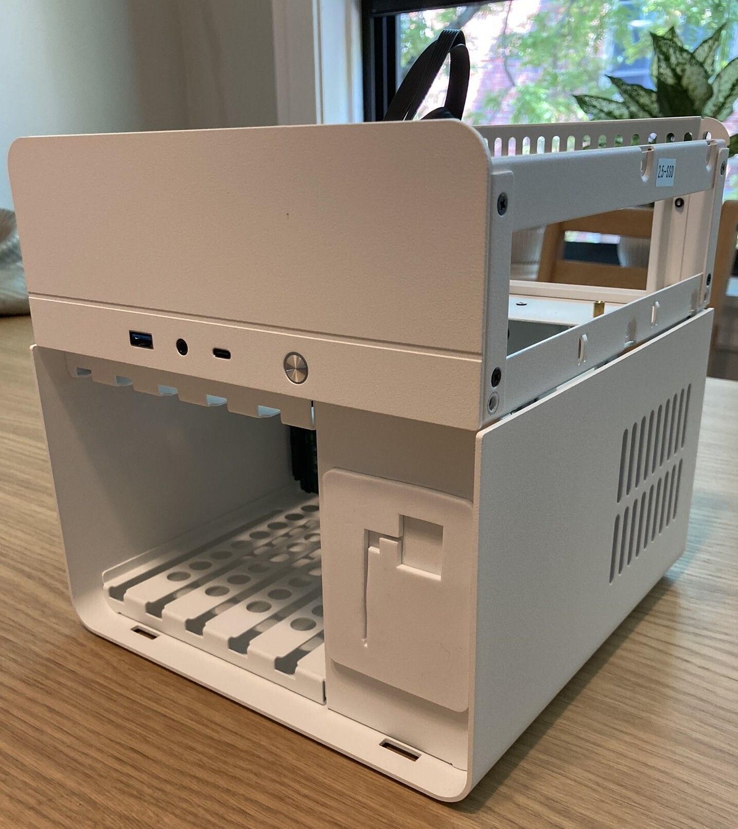 The Jonsbo N2 after removing the drive cage dust cover and the top cover, complete with the unnecessary hex key holder.