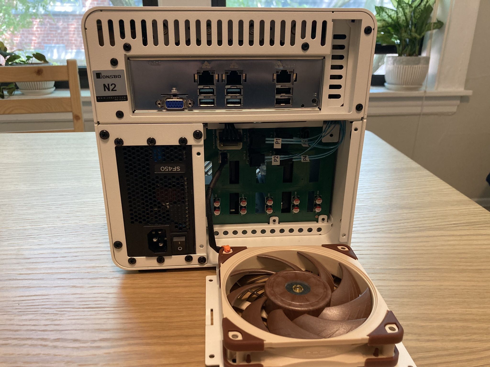It is possible to fit a 25mm fan, although it is a very tight squeeze. I bought a set of right-angled SATA connectors but the main issue is the molex connectors.